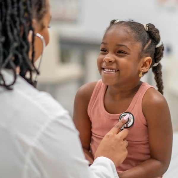 Doctor examining a smiling child
